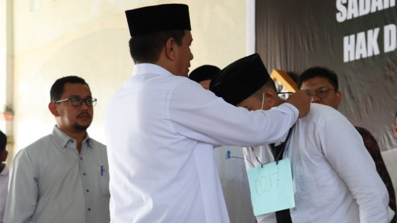 Foto : Rektor IAIN Langsa Dr. H. Basri, MA menyematkan tanda pengenal kepada peserta PBAK.